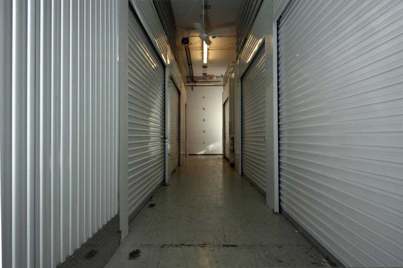 Hallway with storage lockers on both sides.